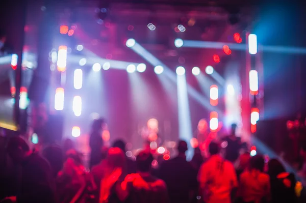 Color disco club light with laser show and dancing people — Stock Photo, Image