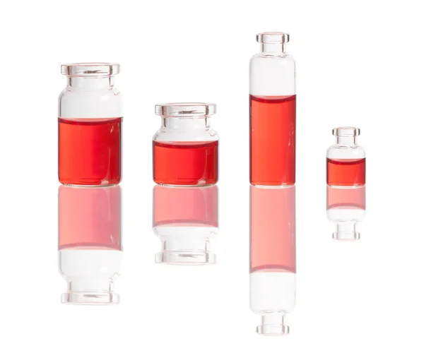 Red liquid in bottles — Stock Photo, Image