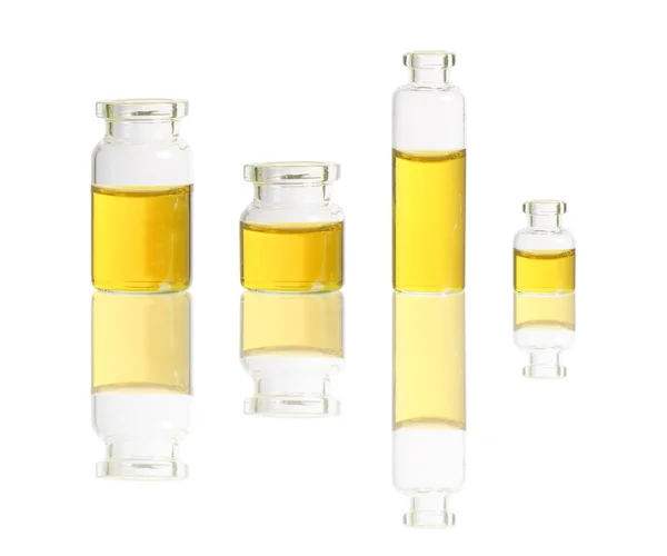 Yellow liquid in bottles — Stock Photo, Image