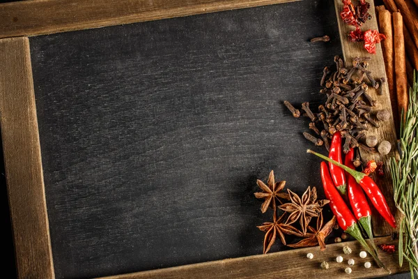 Herbs and spices with chalk board — Stock Photo, Image