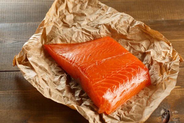 Salmon steak on old papper. — Stock Photo, Image