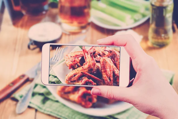 Using smartphones to take photos of BBQ wings set 스톡 사진