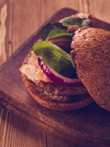 Burger on wooden background. — Stock Photo, Image