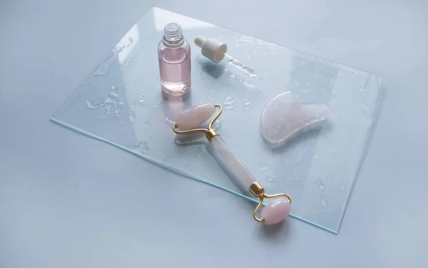Facial massage attributes: Guasha scraper, cosmetic oil and facial roller