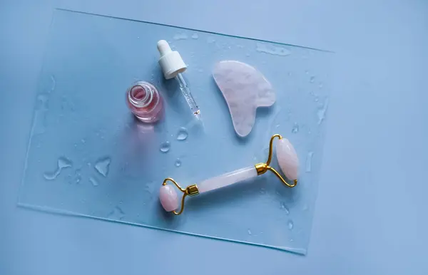 Facial massage attributes: Guasha scraper, cosmetic oil and facial roller