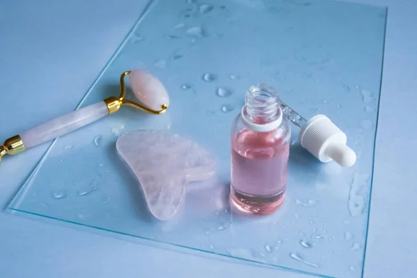 Facial massage attributes: Guasha scraper, cosmetic oil and facial roller