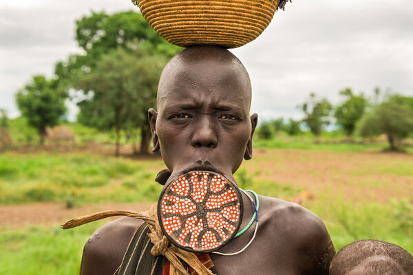 Woman from the african tribe Mursi with a big lip plate