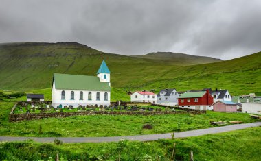 Small village church with cemetery in Gjogv, Faroe Islands, Denm clipart