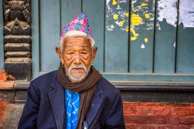 Elderly man sitting in the street of Kathmandu, Nepal