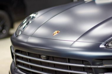 Siyah bir Porsche Cayenne 'e koruyucu boya ve vernikli mat film monte edilmiş. PPF poliüretan film araba boyasını taşlardan ve çiziklerden korur, bulanık odak sağlar. Chelyabinsk, Rusya, 3 Nisan 2021