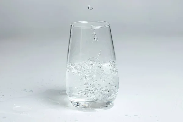 Glass of mineral carbonated water with ice