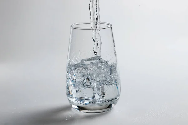 Glass of mineral carbonated water with ice