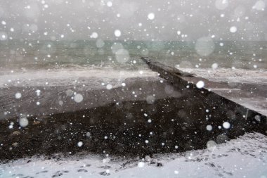 Kışın Karadeniz kıyısında bir sahil. Deniz dalgaları ve kar, güçlü kar fırtınası..