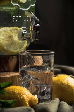 Limonlu soğuk su. Ev yapımı limonata. Karanlık bir arka planda hayat. 