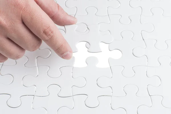 Missing jigsaw puzzle piece with light glow — Stock Photo, Image