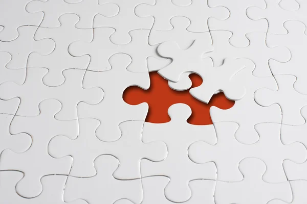 Missing jigsaw puzzle piece with light glow — Stock Photo, Image