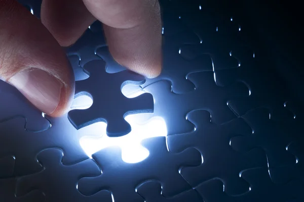 Missing jigsaw puzzle piece with light glow — Stock Photo, Image