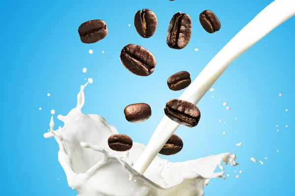 Coffee Beans Falling Into Glass of Milk — Stock Photo, Image