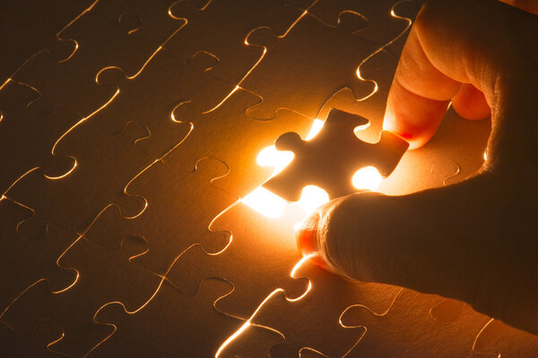 Hand holding Missing jigsaw puzzle piece