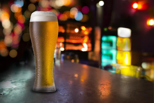 Glass of beer with bar scene — Stock Photo, Image