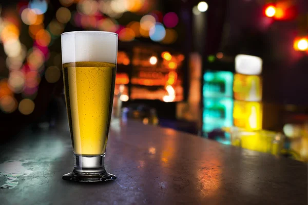 Glass of beer with bar scene — Stock Photo, Image