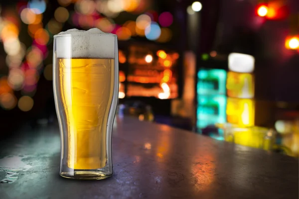 Glass of beer with bar scene — Stock Photo, Image