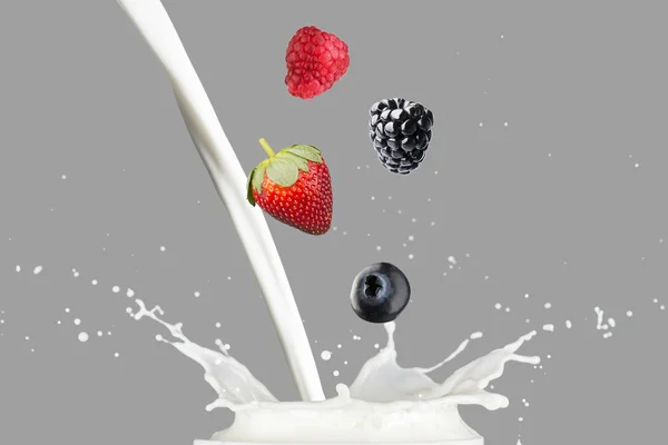 Various Berries Falling On Milk — Stock Photo, Image