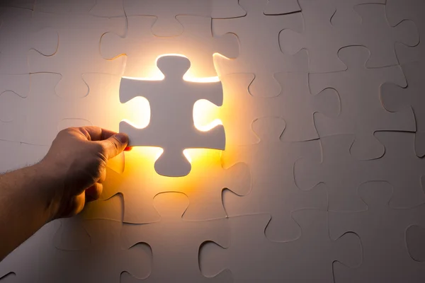 Hand holding jigsaw puzzle piece — Stock Photo, Image