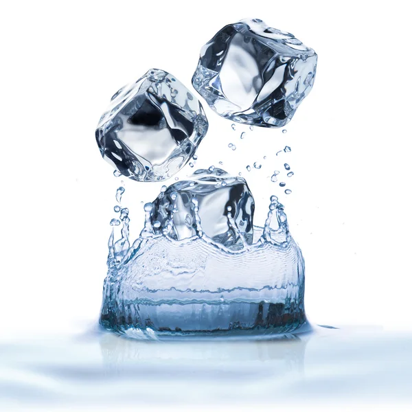 Ice cubes dropped into water — Stock Photo, Image