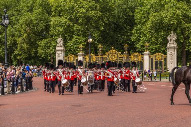 LONDON, UK - 28TH JUNE 2016:  Musicians at the Changing of the Guard Performance at Buckingham Palace in the summer. A police escort can be seen. clipart