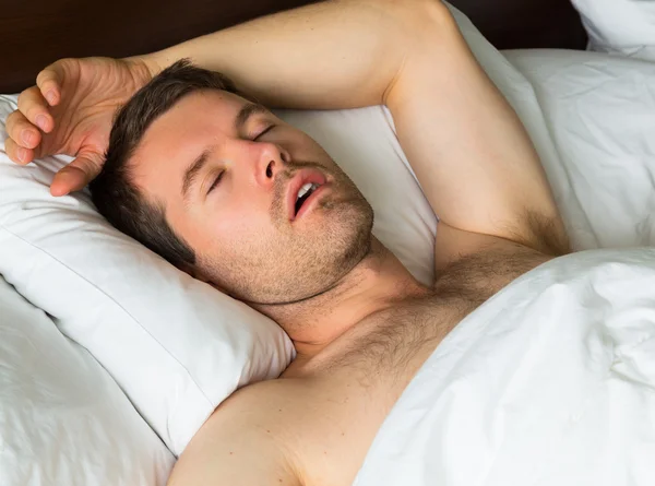 Sleeping man with his arm up — Stock Photo, Image