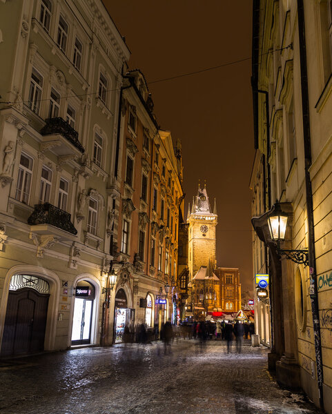 PRAGUE, CZECH REPUBLIC - 6TH JANUARY 2016: A view towards Old Town Square in Prague at night from Celetna Street. The blur of people can be seen.