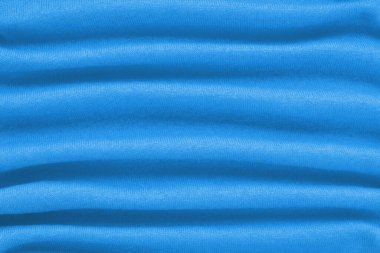 Dalgalı katları olan güzel mavi yün kumaş arka plan. Boşluğu kopyala.