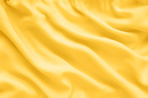 Gelbe Seidentextur Abstrakter Hintergrund Luxusstoff Mit Gewellten Falten lizenzfreie Stockfotos