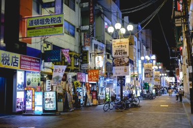 Osaka, Japan: Streets of Dotonbori district with restaurants, neon, wires, colors and people