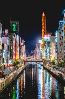 Osaka, Japan: Dotonbori canal with night lights, restaurants, neon, wires, colors and people