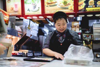 Osaka, Japonya: McDonalds restoranında hizmet veren mutlu Japon kız