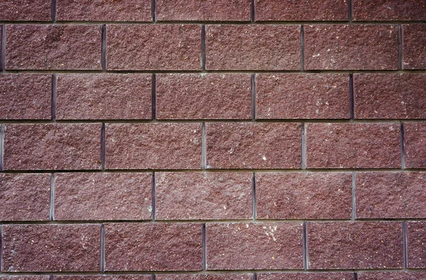 Стена больших прямоугольных камней вишневого цвета в качестве задней части — стоковое фото