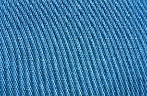 Textura de una tela impermeable sintética tejida azul — Foto de Stock