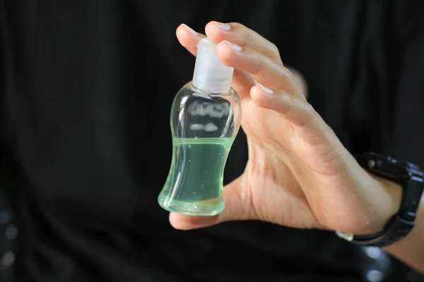 Man hands holding Hand sanitizer gel bottle