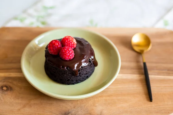 chocolate fondant cake. Mini cake for fondant with icing. Delicious  dessert.Homemade chocolate lava cake.Fondant Lava Cupcake.Warm chocolate dessert.Chocolate cake.Cupcake with berries.Sweet.