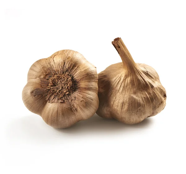 Black or brown garlic on a white background with a soft shadow — Stock Photo, Image