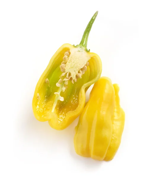 Fresh and tasty yellow habanero pepper cut through half on a whi — Stock Photo, Image