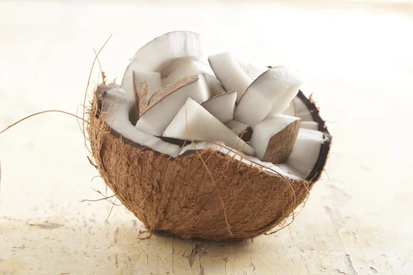 Half coconut filled with coconut chunks — Stock Photo, Image