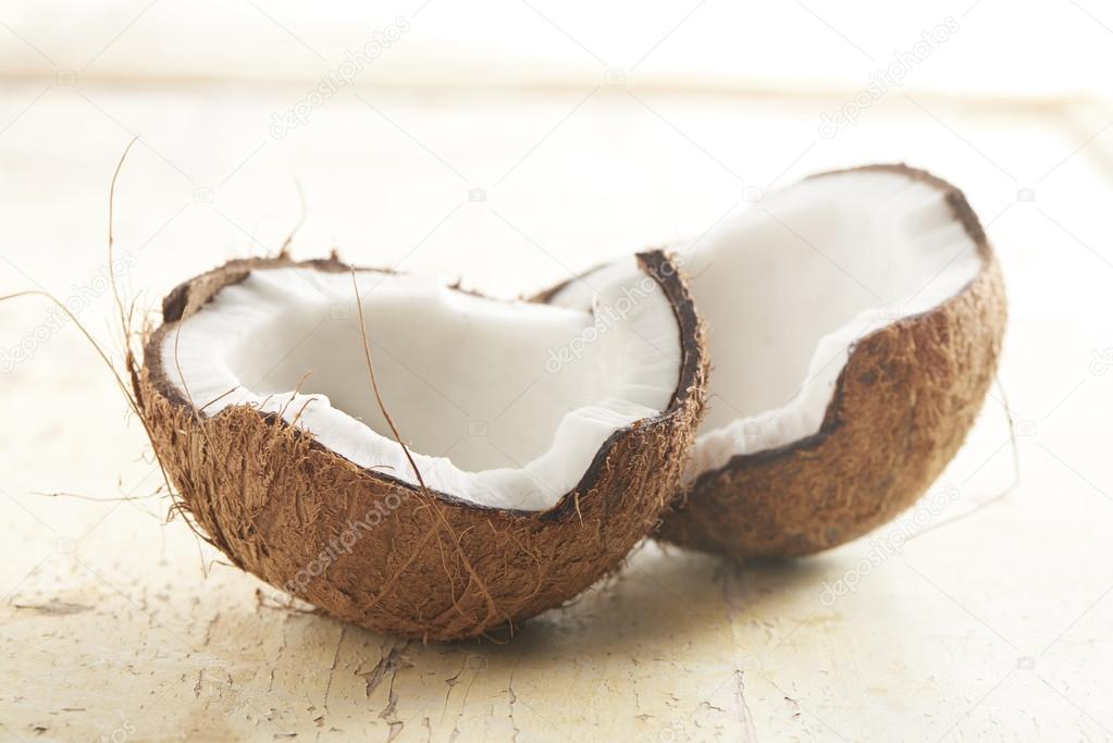 coconut cut in half on a wooden background