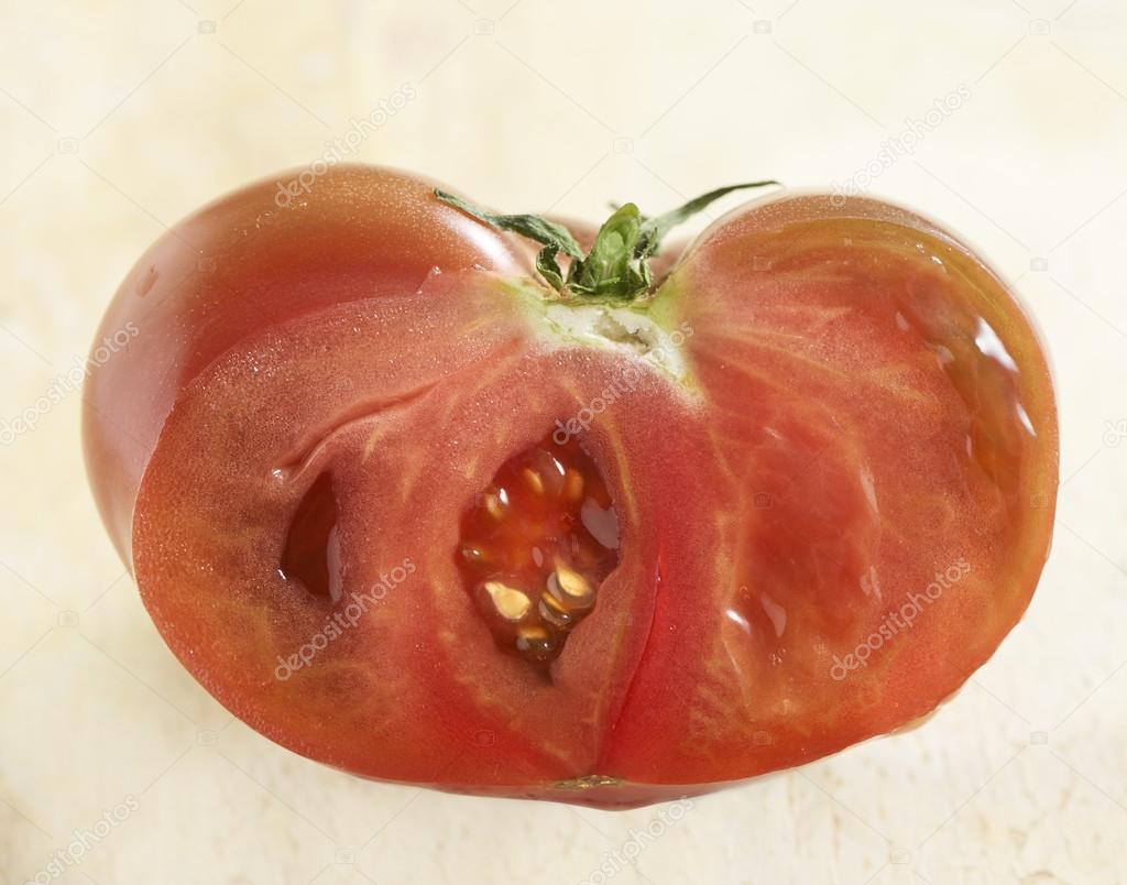 Ripe coeur de boeuf tomato cut through Stock Photo by ©Greatstock 91459934