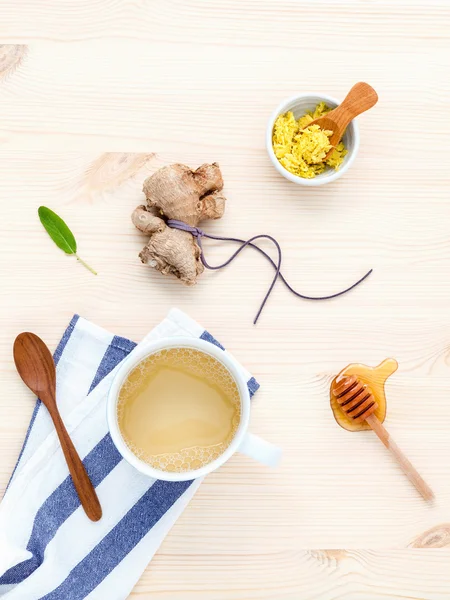 The cup of ginger tea with ginger roots , honey and mint on rust — Stock fotografie