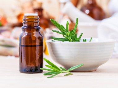 Fresh rosemary and essential oil with shallow depth of field set clipart