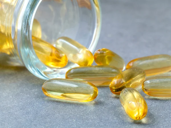 Close up capsules fish oil in Glass bottle .The supplement high — Stock Photo, Image