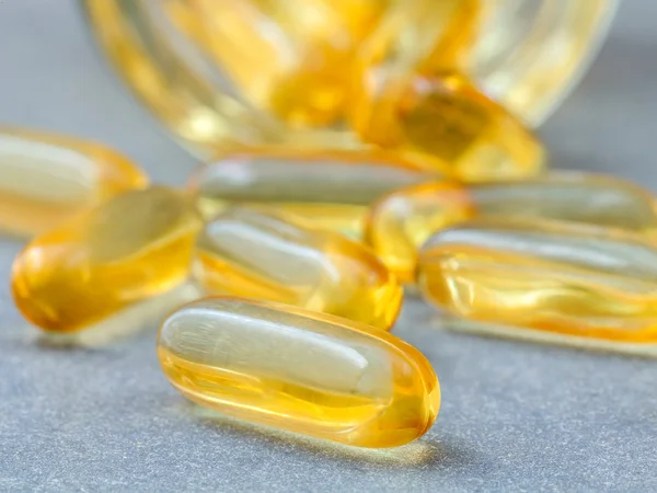 Close up capsules fish oil in Glass bottle .The supplement high — Stock Photo, Image